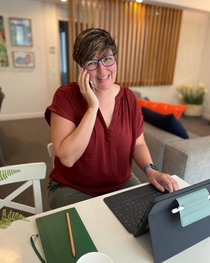Kim Matthews, founder of Sparks Scribe, working at her desk